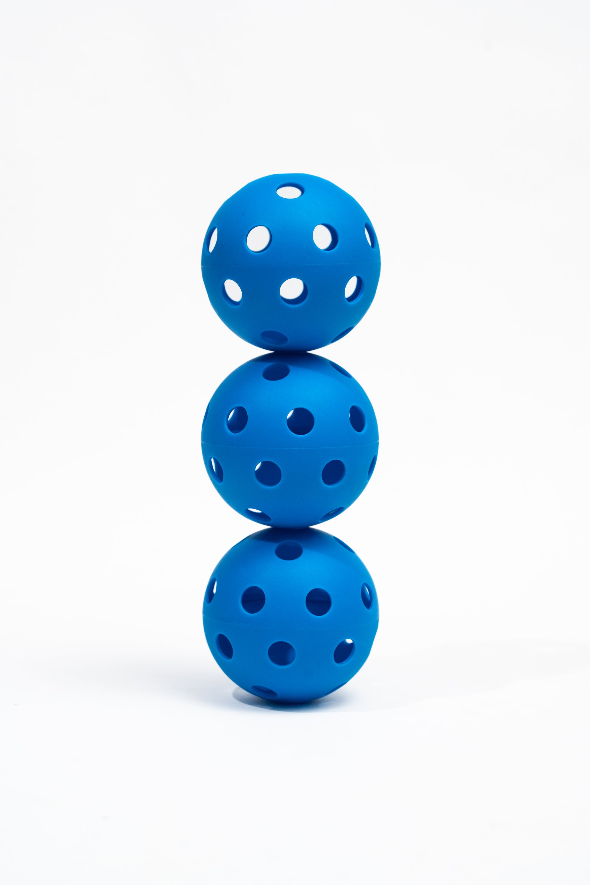 Three blue pickleball balls stacked on a white background, Orb 40 pickleball, Kourtcraft