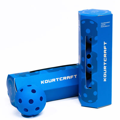Blue pickleball ball and packaging with 'Kourtcraft' branding on a blue background. Orb 40